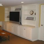 Built-in cabinets with media storage for a finished basement